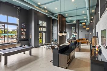 Gaming lounge with billiards, foosball, shuffleboard, and vintage arcade games